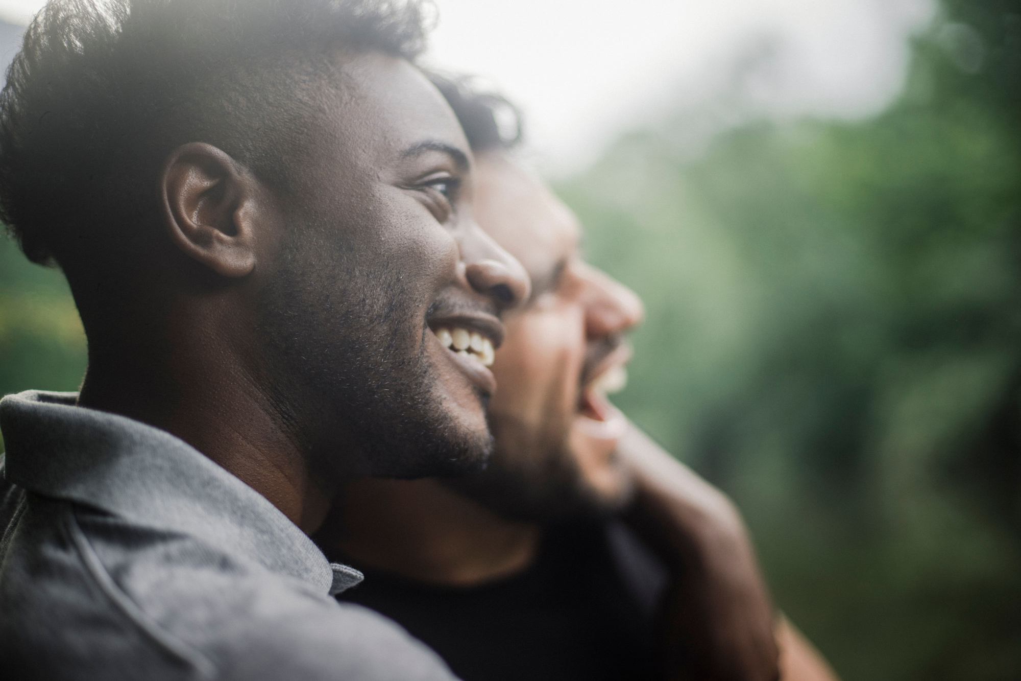 Two men sharing a smile outdoors